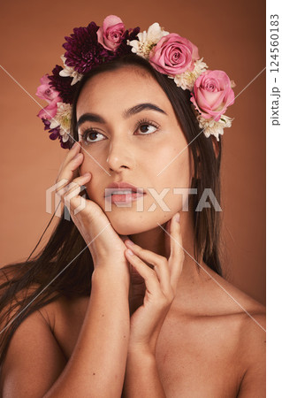 Beauty, hair flowers and woman in makeup on brown studio background. Floral cosmetics, skincare and young, elegant and thinking female model, posing with roses or plants for healthy skin treatment. Beauty, hair flowers and woman in makeup on brown studio background. Floral cosmetics, skincare and young, elegant and thinking female model, posing with roses or plants for healthy skin treatment. 124560183