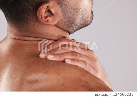 Man hand holding neck pain, hurt and body injured problem in studio. Male model hands from behind suffering with sore body injury, discomfort and strain or muscle sprain from fractured joints 124560235