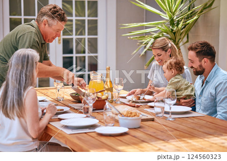 Family, food and love with a man, woman and parents eating a meal together around a dining room table. Children, dinner and bonding with grandparents, inlaws and grandkids spending time in the home 124560323