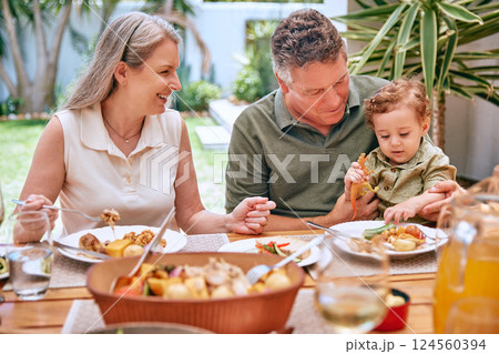 Family, dinner and eating food at restaurant together smile and happy grandparents bonding with child. Elderly couple, healthy leisure lifestyle and wellness teaching or feeding kid vegetable stew. 124560394