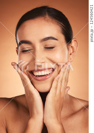 Face, beauty smile and woman with eyes closed on brown studio background. Makeup, skincare and female model from Australia with hands on face for smooth skin routine, perfect teeth and wellness. Face, beauty smile and woman with eyes closed on brown studio background. Makeup, skincare and female model from Australia with hands on face for smooth skin routine, perfect teeth and wellness. 124560421