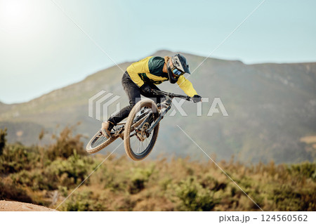Mountain bike, man and action air jump and bicycle, challenge and adventure, freedom and fast race in nature. Cycling sports athlete, training and energy on mountain for outdoor speed competition 124560562