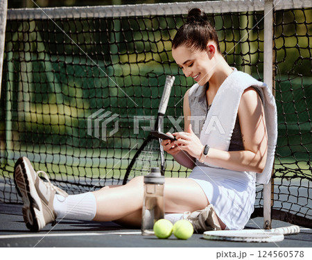 Relax, fit and phone with woman tennis player browsing, social media or web outdoor on the court. A happy young female athlete or sportswoman posting her sport training online or on the internet Relax, fit and phone with woman tennis player browsing, social media or web outdoor on the court. A happy young female athlete or sportswoman posting her sport training online or on the internet 124560578