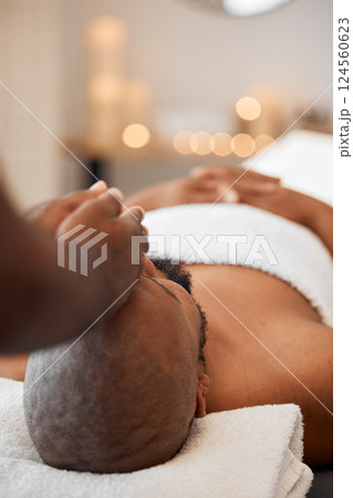 Black man, head massage or relax spa in relax hotel, wellness salon or luxury resort for self care, mental health or peace. Massage therapist, hands and zen aromatherapy for healthy stress management 124560623