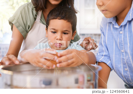 Family, cooking and child learning about baking with eggs in home kitchen with mom teaching kid to bake. Boy, woman and sibling together while helping to cook a meal, cake or food for quality time Family, cooking and child learning about baking with eggs in home kitchen with mom teaching kid to bake. Boy, woman and sibling together while helping to cook a meal, cake or food for quality time 124560641