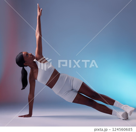 Black woman, yoga fitness stretching and body wellness workout. Young athlete person, healthy lifestyle motivation and sports exercise muscle training for cardio on floor in blue background studio 124560685