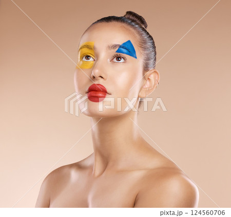 Makeup, clown and young woman with facial art, natural beauty and wellness with brown studio background. Artist, female and girl being creative, with pride and confident with cosmetics or face paint. 124560706