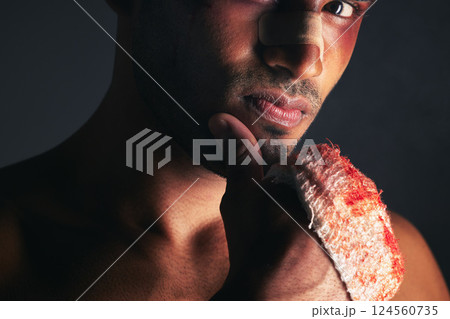 Fight, blood and portrait of man with bruise on eye, face and bloody bandages on hand. Violence, boxing and young male boxer with injury, wounds and hurt from mma sport on black background in studio 124560735
