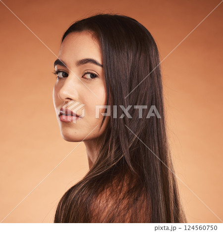Hair care, beauty and face portrait of woman on brown studio background. Luxury makeup, skincare and female model with beautiful, healthy and long hair after salon hair treatment for clean hairstyle. 124560750