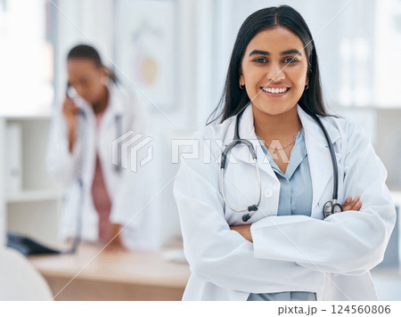 Indian woman, doctor and arms crossed in hospital with trust, wellness goals or healthcare motivation. Portrait, smile or happy medical worker, life insurance employee or friendly consulting surgeon Indian woman, doctor and arms crossed in hospital with trust, wellness goals or healthcare motivation. Portrait, smile or happy medical worker, life insurance employee or friendly consulting surgeon 124560806