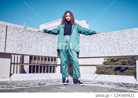 Fashion, stylish and woman in the city with freedom, style and designer clothes in Singapore. Creative, young and portrait of a girl with urban, trendy and street clothing against blue sky in summer 124560921