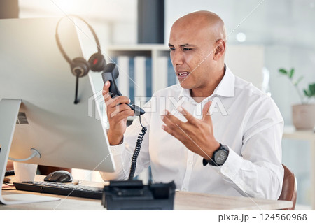 Call center, customer service and arguing with a frustrated man at work in a telemarketing office. Contact us, consulting and angry with an annoyed male working as a sales, support or crm agent 124560968