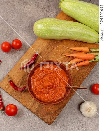 Zucchini caviar with ingredients for cooking on a concrete table, the concept of home canning and harvesting vegetables, healthy organic food, tomatoes, zucchini, carrots and peppers on the kitchen Zucchini caviar with ingredients for cooking on a concrete table, the concept of home canning and harvesting vegetables, healthy organic food, tomatoes, zucchini, carrots and peppers on the kitchen 124561093