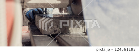 Wide low angle view through an angle grinder of the circular saw blade 124561195