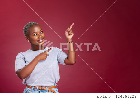 Black woman, mockup and pointing for advertising, marketing or banner against a studio background. Happy African American female point to empty copyspace for sale advertisement text, message or brand 124561228