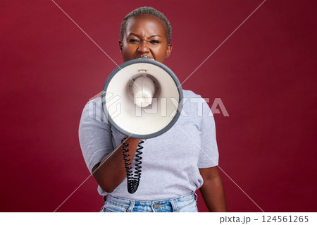 Megaphone, noise and woman in studio for vote, voice and message of change, transformation and democracy on red background. Speaker, black woman and portrait girl speaking protest, strike and opinion Megaphone, noise and woman in studio for vote, voice and message of change, transformation and democracy on red background. Speaker, black woman and portrait girl speaking protest, strike and opinion 124561265