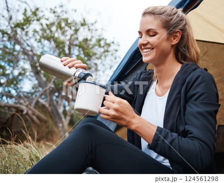 Camping, coffee and woman in nature by tent on vacation, holiday or trip. Tea, travel and female camper from Canada relaxing in woods, forest or grass field while pouring hot beverage from bottle. Camping, coffee and woman in nature by tent on vacation, holiday or trip. Tea, travel and female camper from Canada relaxing in woods, forest or grass field while pouring hot beverage from bottle. 124561298