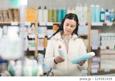 Woman choosing body creams at the pharmacy Woman choosing body creams at the pharmacy 124561429