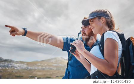 Pointing, travel and couple hiking on the mountains in a natural environment for an outdoors adventure in Canada. Freedom, lifestyle and healthy woman loves walking or trekking with partner in nature 124561450