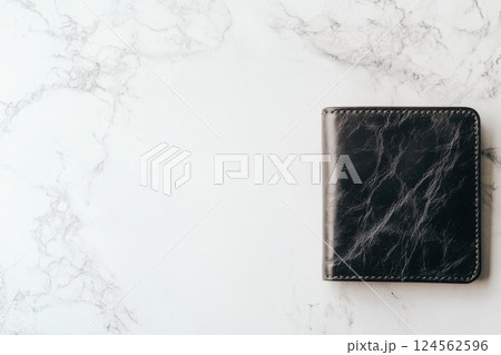 Elegant leather wallet resting on a light marble surface showcasing fine craftsmanship and design 124562596