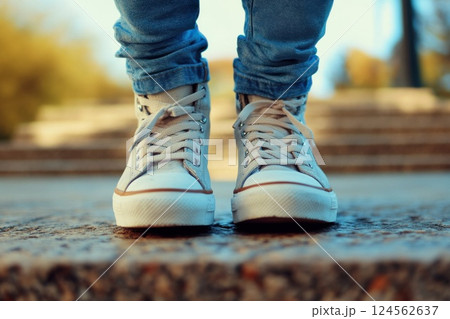 Teenager skipping down concrete stairs in city park wearing sneakers 124562637
