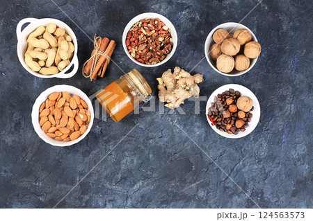 Assortment of different nuts, the concept of healthy natural food, almonds, pecans, pistachios, cashews, walnuts and pine nuts, high-calorie food with vegetable protein and vitamins, the basis of diet 124563573