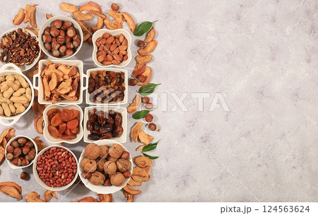 Assortment of various nuts and dried fruits, healthy natural food concept, almonds, nuts, pecans, pistachios, cashews, walnuts and pine nuts, apples, raisins, dried apricots, food with vegetable Assortment of various nuts and dried fruits, healthy natural food concept, almonds, nuts, pecans, pistachios, cashews, walnuts and pine nuts, apples, raisins, dried apricots, food with vegetable 124563624