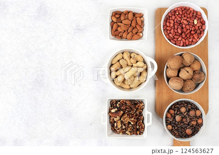 Assortment of various nuts, the concept of healthy natural nutrition, almonds, pecans, pistachios, cashews, walnuts and pine nuts, high-calorie food with vegetable protein and vitamins, the basis of 124563627