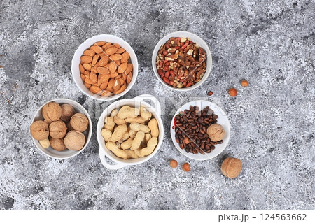 Assortment of different nuts, the concept of healthy natural food, almonds, pecans, pistachios, cashews, walnuts and pine nuts, high-calorie food with vegetable protein and vitamins, the basis of diet 124563662