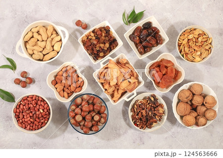 Assortment of various nuts and dried fruits, healthy natural food concept, almonds, nuts, pecans, pistachios, cashews, walnuts and pine nuts, apples, raisins, dried apricots, food with vegetable Assortment of various nuts and dried fruits, healthy natural food concept, almonds, nuts, pecans, pistachios, cashews, walnuts and pine nuts, apples, raisins, dried apricots, food with vegetable 124563666