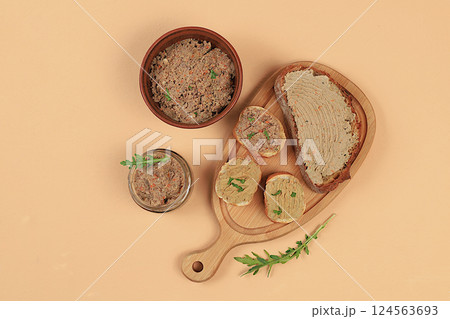 Chicken pate with homemade whole grain bread and herbs on a light table, the concept of a healthy lifestyle and natural nutrition. Healthy breakfast with ingredients, advertising for a cafe, selective 124563693