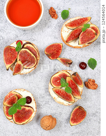 Ricotta,figs and bruschetta with honey on gray marble.Fresh sandwiches and toast with cream cheese,sliced figs,honey and cherries.Healthy breakfast with ingredients,lunch or dessert,diet food Ricotta,figs and bruschetta with honey on gray marble.Fresh sandwiches and toast with cream cheese,sliced figs,honey and cherries.Healthy breakfast with ingredients,lunch or dessert,diet food 124564014