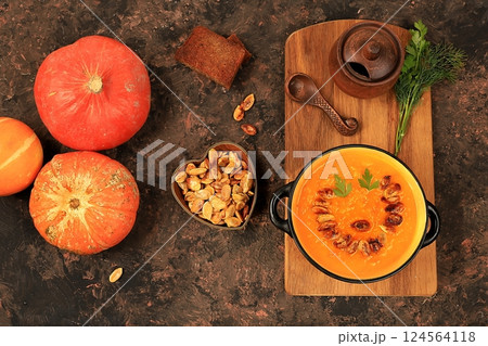 Pumpkin and zucchini cream soup with roasted seeds and toast,traditional autumn vegan food,healthy natural breakfast,advertising for cafe,restaurant,business card,selective focus Pumpkin and zucchini cream soup with roasted seeds and toast,traditional autumn vegan food,healthy natural breakfast,advertising for cafe,restaurant,business card,selective focus 124564118