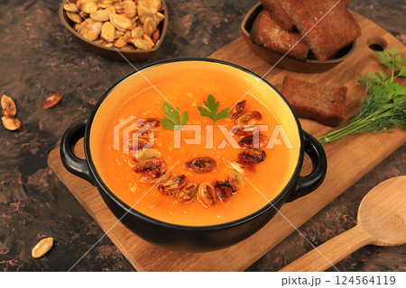 Pumpkin and zucchini cream soup with roasted seeds and toast,traditional autumn vegan food,healthy natural breakfast,advertising for cafe,restaurant,business card,selective focus Pumpkin and zucchini cream soup with roasted seeds and toast,traditional autumn vegan food,healthy natural breakfast,advertising for cafe,restaurant,business card,selective focus 124564119