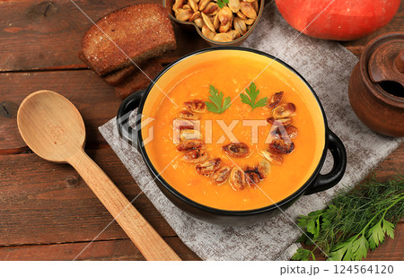 Pumpkin and zucchini cream soup with roasted seeds and toast,traditional autumn vegan food,healthy natural breakfast,advertising for cafe,restaurant,business card,selective focus Pumpkin and zucchini cream soup with roasted seeds and toast,traditional autumn vegan food,healthy natural breakfast,advertising for cafe,restaurant,business card,selective focus 124564120