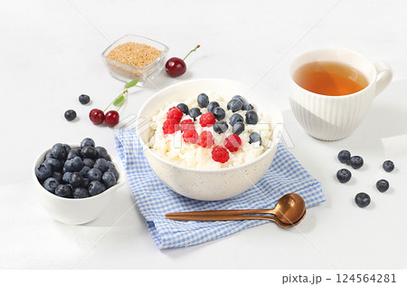 Healthy breakfast with ingredients, milk rice porridge with fresh blueberries, cherries and raspberries, creamy rice pudding with flax seeds and chamomile tea. Natural nutrition and weight loss Healthy breakfast with ingredients, milk rice porridge with fresh blueberries, cherries and raspberries, creamy rice pudding with flax seeds and chamomile tea. Natural nutrition and weight loss 124564281