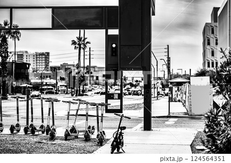 Row of electric scooters in an urban campus street crossroad.  124564351