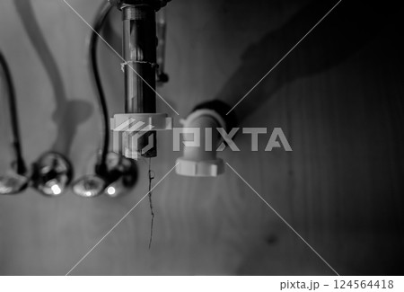 selective focus on a bathroom sink drain disconnected with a hair clog hanging down selective focus on a bathroom sink drain disconnected with a hair clog hanging down 124564418
