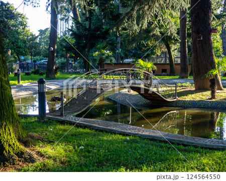 Park at sunset. Nice quiet place. Round bridge on the pond 124564550
