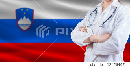 doctor with crossed arms on slovenian flag; slovenia health and care concept; female doctor on slovenian flag doctor with crossed arms on slovenian flag; slovenia health and care concept; female doctor on slovenian flag 124564974