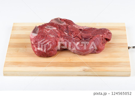 Uncooked raw beef meat on wooden cutting board. 124565052