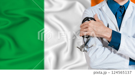 Doctor with stethoscope on Ireland flag. Doctor holding stethoscope on Ireland flag 124565137