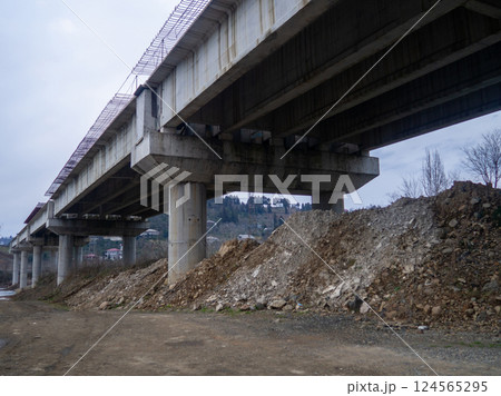 under the overpass. Terrible deserted place. Danger. Gloomy atmosphere. Industrial zone. 124565295
