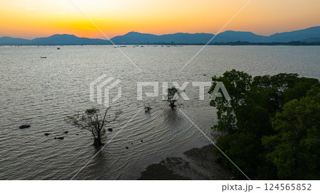 Aerial view of the golden sun slow down behind the mountain 124565852
