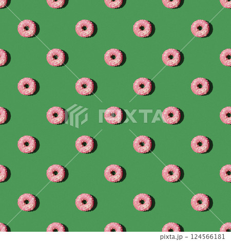 Seamless pattern with pink donuts on the green background. Concept of the New Year, Christmas, Celebration. Food background Seamless pattern with pink donuts on the green background. Concept of the New Year, Christmas, Celebration. Food background 124566181