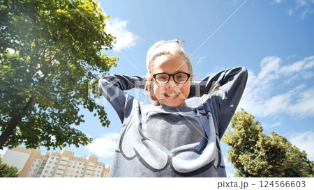 Teenager girl in a cap funny and fun poses in front of a wide-angle fisheye lens cam. Face close-up. 124566603