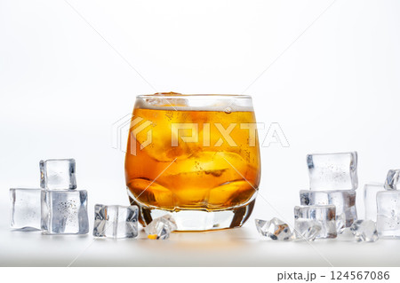 Sparkling drink. A glass of apple spritzer or Apfelschorle on a white background. Cold carbonated apple juice. Homemade spritzer served with ice. Sparkling drink. A glass of apple spritzer or Apfelschorle on a white background. Cold carbonated apple juice. Homemade spritzer served with ice. 124567086