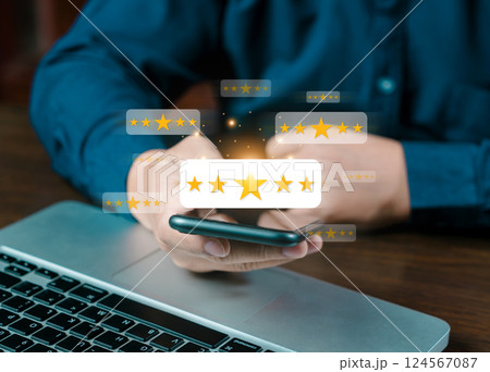 Online customer satisfaction survey service, The customer is hand-press on the smartphone with gold five-star rating feedback icon and pressing excellent rank to give the best score point for review Online customer satisfaction survey service, The customer is hand-press on the smartphone with gold five-star rating feedback icon and pressing excellent rank to give the best score point for review 124567087