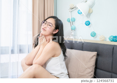 Asian Glasses Woman relax on her bed in the morning at her bedroom. Asian Glasses Woman relax on her bed in the morning at her bedroom. 124568731