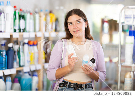 Young woman choosing deodorant in store Young woman choosing deodorant in store 124569882